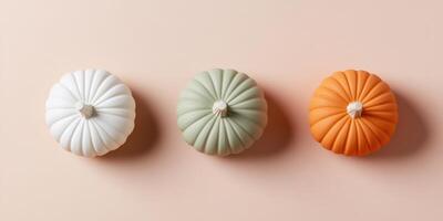 Festive arrangement of three small decorative pumpkins for autumn decor photo