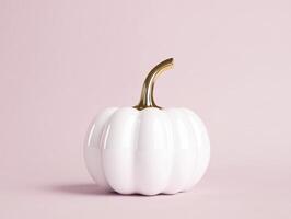 Elegant white ceramic pumpkin with gold stem on soft pink background for decorative display photo