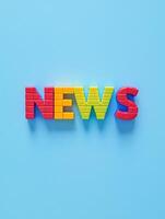 Colorful plastic lettering of the word news on blue background for communication design photo