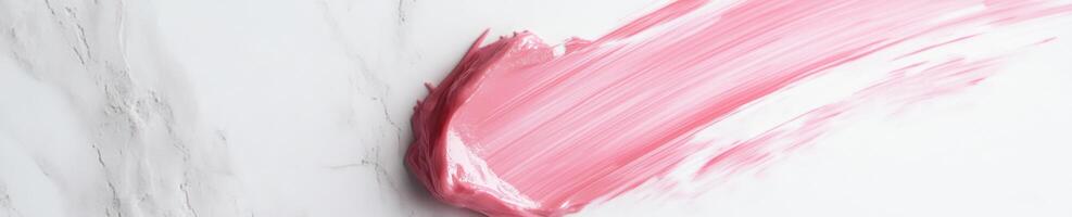Elegant abstract design featuring a transparent pink brush stroke on a marble background photo