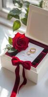 Luxurious gift box with red velvet interior, rose and rings for romantic occasions photo