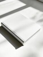Blank hardcover book lying on bright white surface for mockup and design use photo