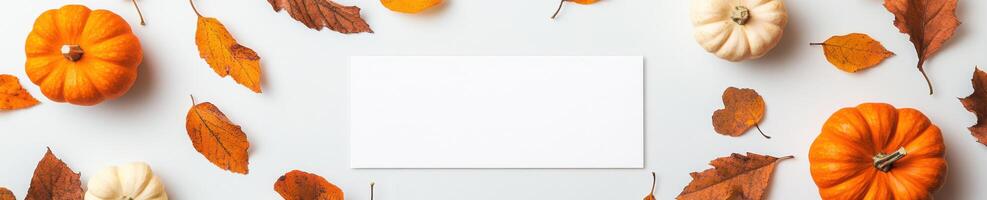 Autumn themed mock up of floating white postcard with pumpkins and leaves for seasonal design photo