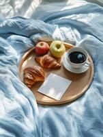 Cozy breakfast in bed for Father day celebration with fresh croissants and coffee photo