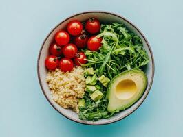 Healthy lunch bowl with quinoa, avocado, cherry tomatoes, and arugula for a nutritious diet photo