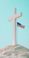 Modern minimalist white cross with American flag on sandy beach photo