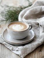 Elegant cappuccino with latte art on linen napkin for cozy cafe atmosphere photo