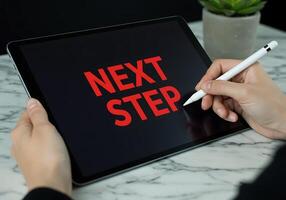Next Step Writing Next Steps on Digital Tablet with Stylus photo