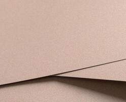 Paper texture with warm beige and soft champagne tones, glossy surface with subtle shimmer, elegant photo