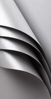 Silver and gray paper texture with metallic shine and pearlescent finish, folded and rolled design photo