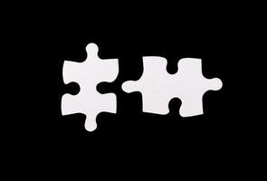 Two puzzle pieces in a business context, symbolizing collaboration, partnership, and synergy. The photo
