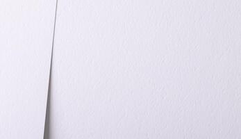 Paper texture with pure white tone, clean smooth surface and perforated layered composition, bright photo