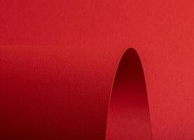 Red paper texture with vibrant fire red and scarlet tones, textured surface with rolled and curved photo
