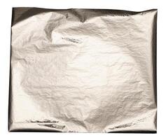 Silver foil texture with polished, crumpled edges. Shiny, metallic surface with a soft, reflective photo