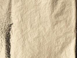 Golden foil texture with a crinkled, metallic surface. Elegant, smooth pattern with warm light and photo