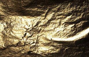 Gold foil with shiny, metallic texture creates a reflective, luxurious surface. Crinkled and creased photo