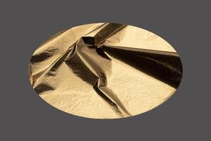 Golden elliptical shape with a sleek, metallic surface creates a modern, geometric design. Wrinkled photo