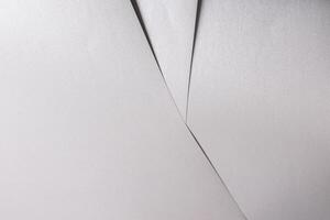 White paper texture with metallic silver and platinum tones, glossy finish and smooth folded surface photo