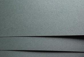 Paper texture with sage green tone, glossy shimmering surface and glitter overlay, elegant layered photo