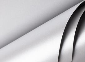 Paper texture with sleek silver and platinum tones, glossy pearlescent surface with shimmering wave photo