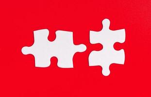 Puzzle pieces with a mismatch against a bold red background, symbolizing disconnect and the photo