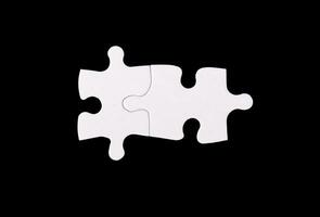 Two interlocked puzzle pieces symbolizing unity and teamwork in a business context. The matching photo