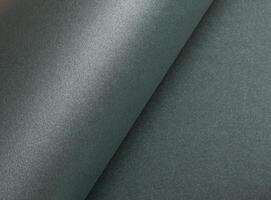 Paper texture with metallic green tone, glossy rolled surface and shimmering gloss finish, elegant photo