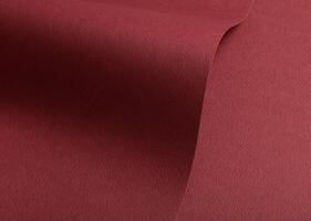 Paper texture with maroon tone, clean wavy fold and perforated surface, deep red designer paper photo