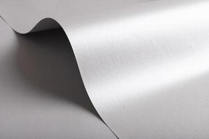 Silver and gray paper texture with metallic gloss, sleek folded and rolled design, wavy edge and photo