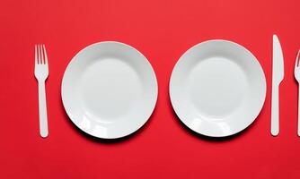 Plate and cutlery isolated on plain background in top view group photo