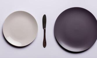 Plate and cutlery isolated on plain background in top view classic photo
