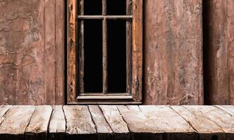 Background with rustic table in the foreground and old abandoned window worn by time in the background. photo
