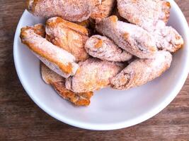 Pieces of frozen fried chicken wings photo