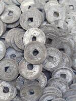 Ancient Chinese money. This money was used by Chinese traders as a means of exchange in ancient times, and has now become a tool for Hindu religious ceremonies in Bali. Money with holes photo