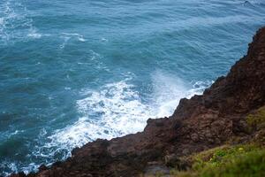 View of the waves crashing against the cliffs of the island. Beautiful sea surface photo