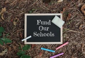 Chalkboard with the words fund Our Schools written on it photo
