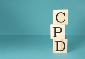 Three wooden blocks stacked on top of each other with the letters CPD photo