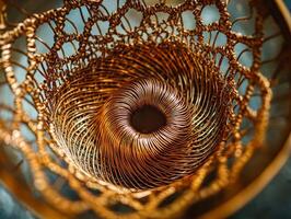 Gold colored object with a wire mesh pattern photo