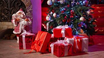Many presents under Christmas tree. Beautiful Santa Claus toy near Christmas tree with gifts in the room. New Year eve. video