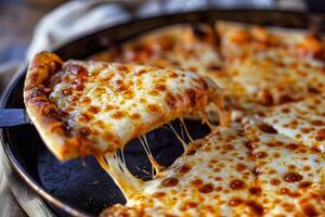 Hot pizza slice with melted cheese being lifted photo