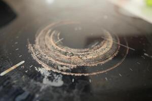 Circular patterns on a worn countertop surface in daylight photo