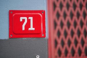 Number 71 on a building facade with distinctive color palette photo