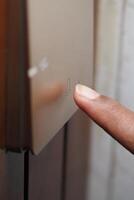 Finger pressing a button on a sleek control panel photo