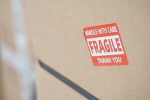 Careful handling of fragile package with warning label photo