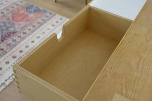 Wooden drawer with an empty space in a modern interior setting photo