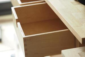 Wooden drawer partially open in a modern workspace photo