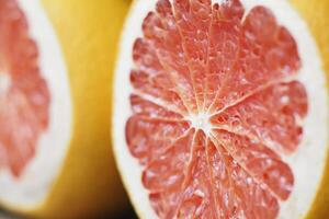 Freshly cut pink grapefruit showing juicy segments and texture photo