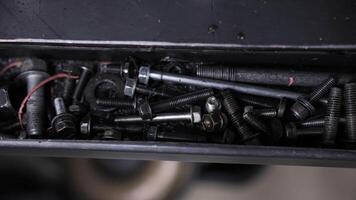 Assorted bolts and screws stored in metal workshop tray video