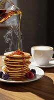 Pouring Maple Syrup on Stacked Pancakes Served with Berries and Coffee photo
