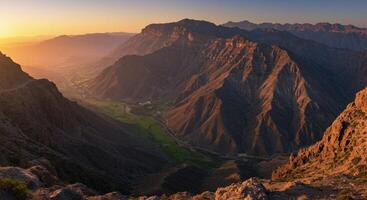 Sunrise Over Majestic Mountain Range with Green Valley in Saudi Arabia photo